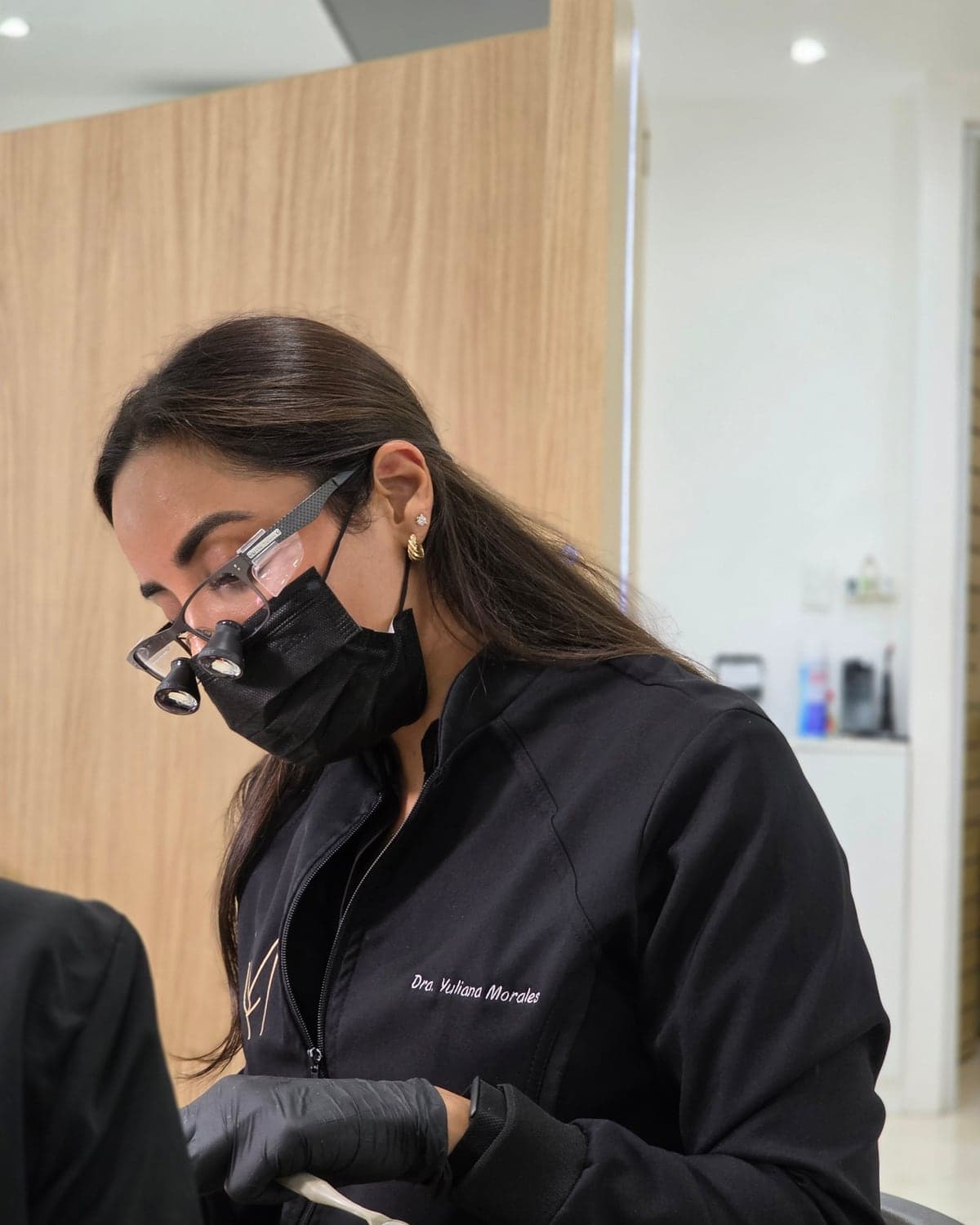 The doctor working with magnifying loupes during a consultation