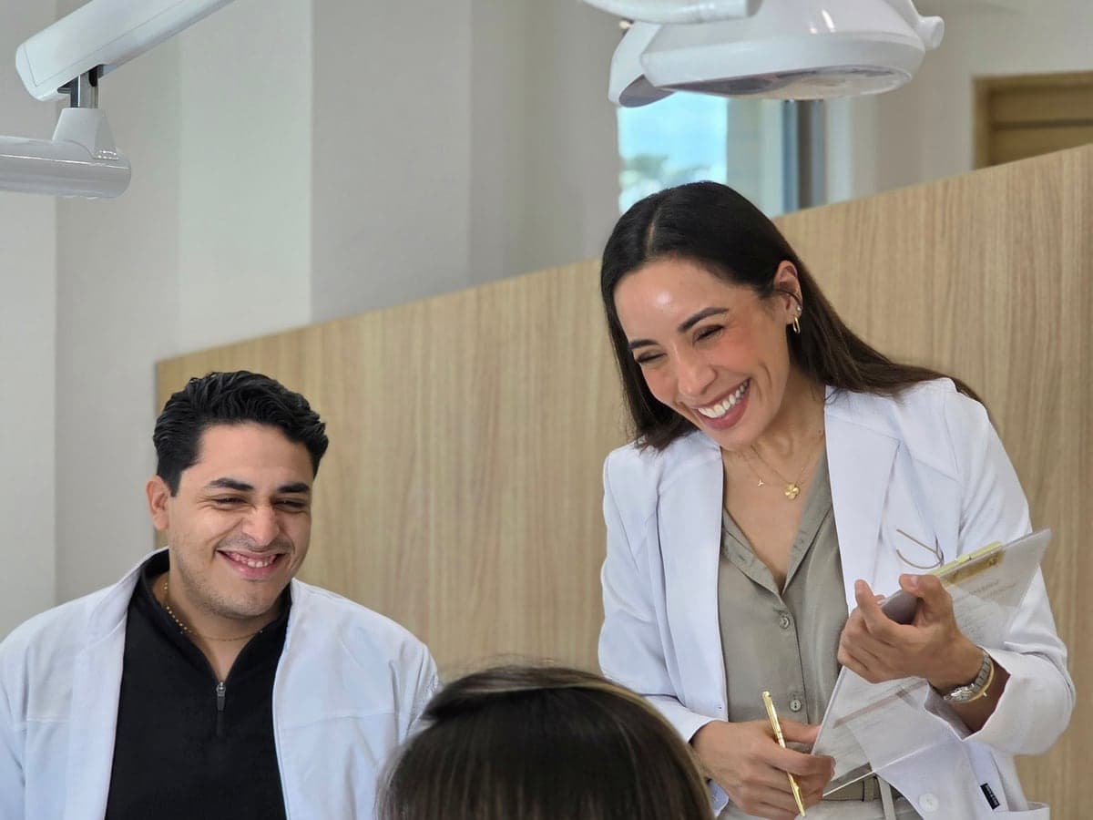 The doctor and her team attending a patient at the dental chair